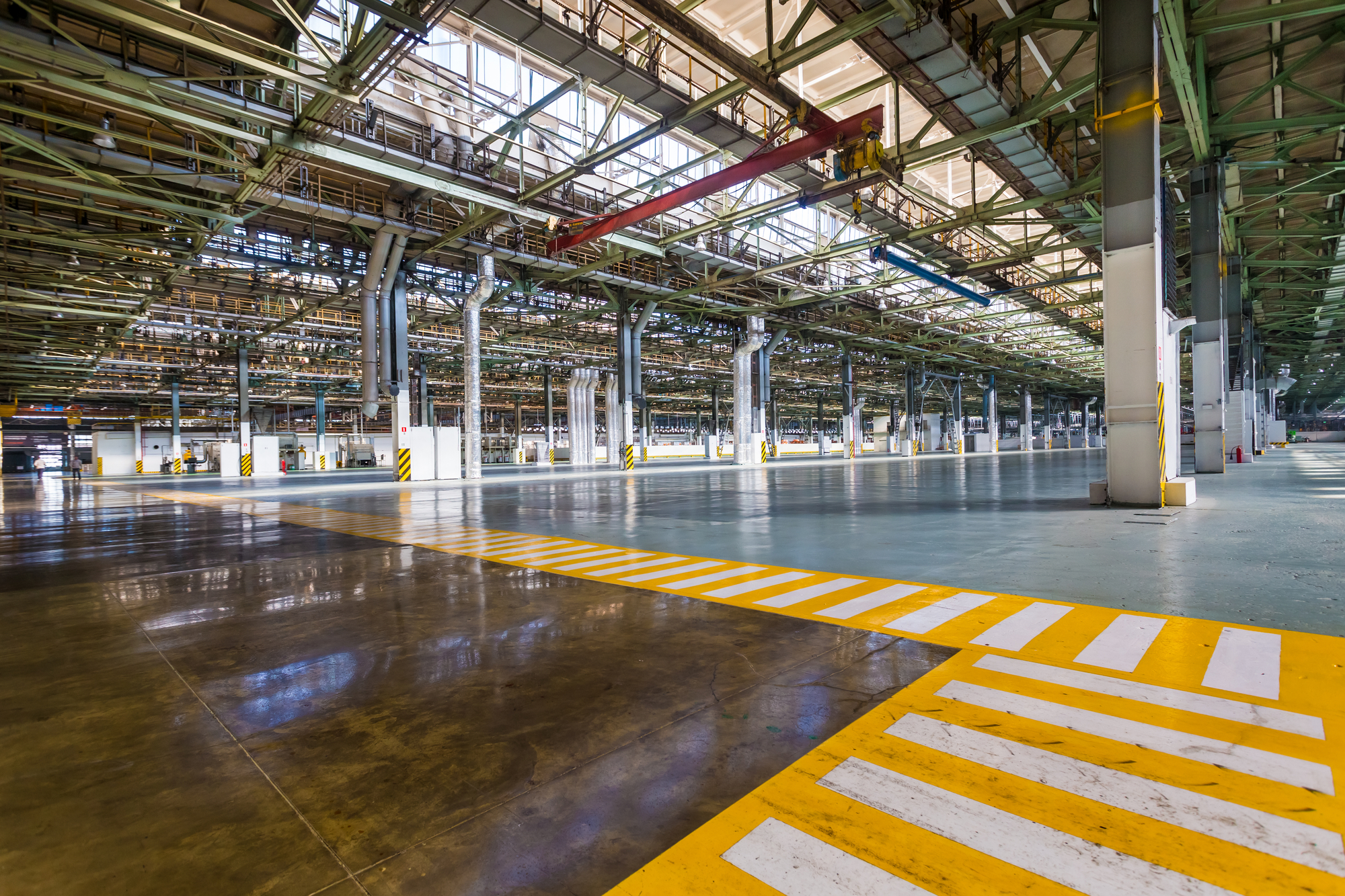 A large warehouse with a yellow striped floor.