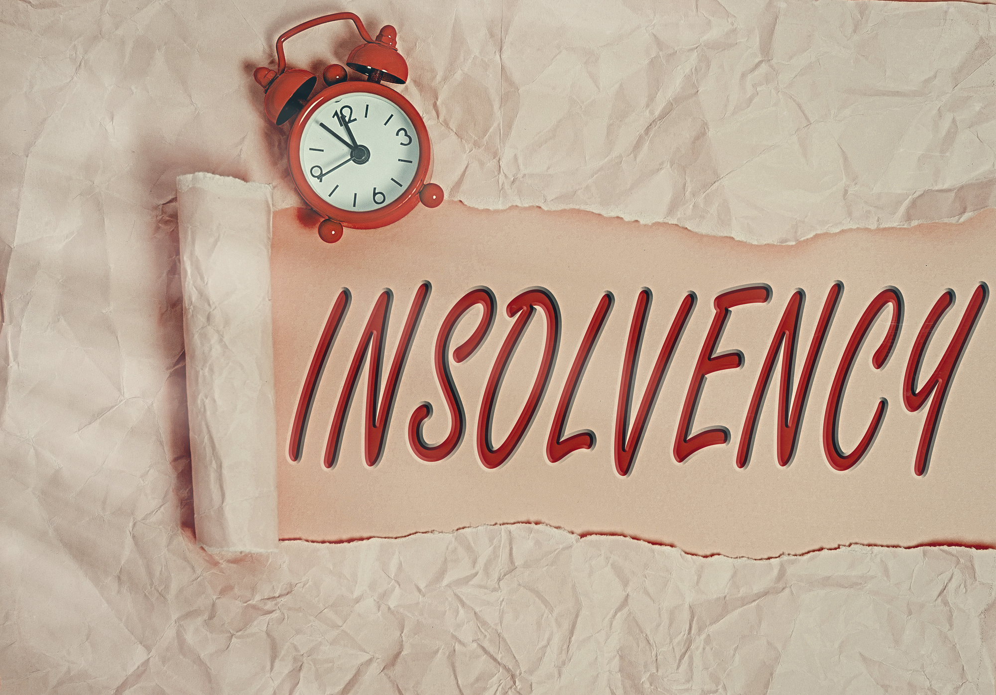 The word insolvency is written on a piece of crumpled paper.