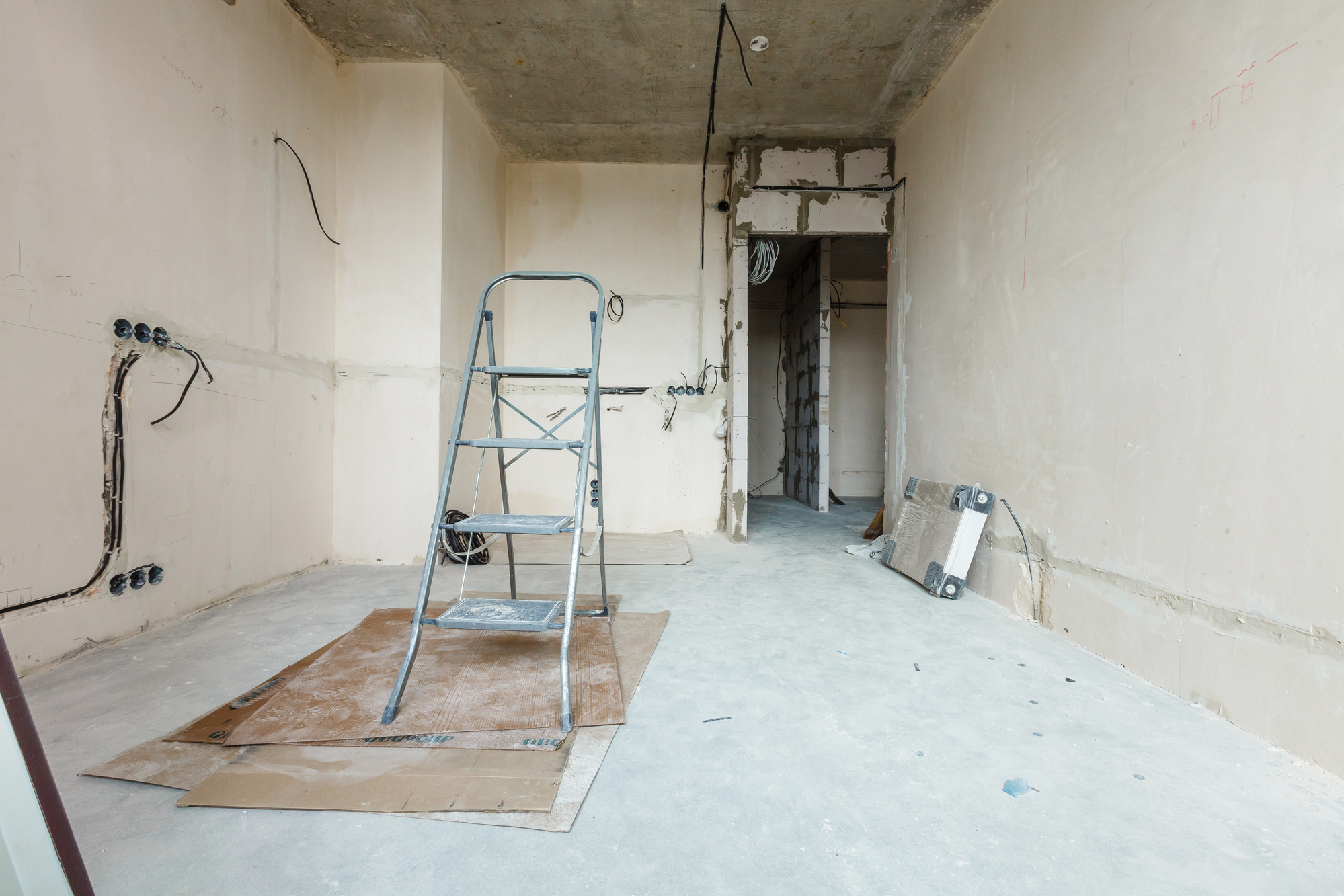 A room that is being remodeled with a ladder and scaffolding.