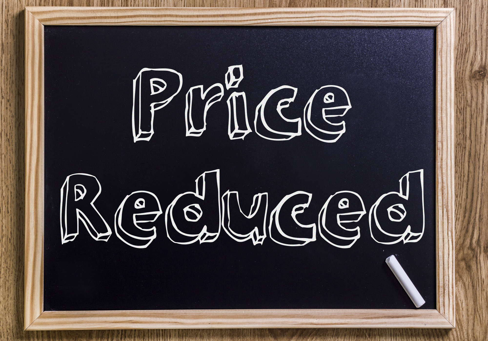 A blackboard with the word price reduced on it.