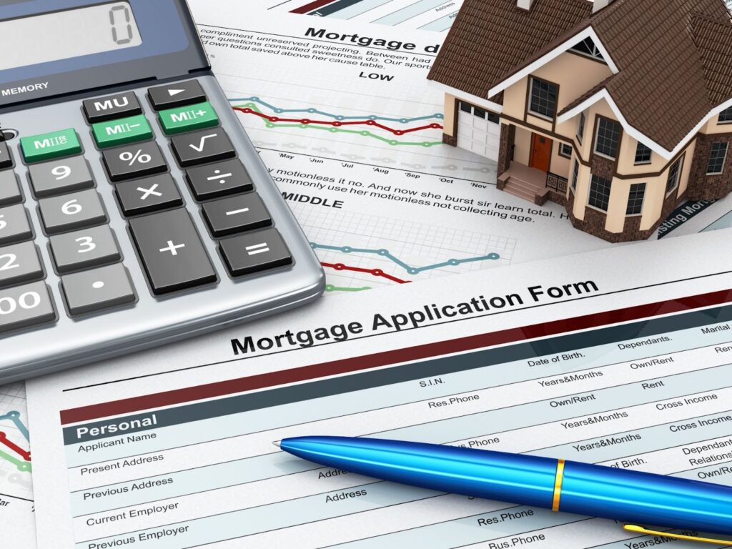 A mortgage application form with a calculator and pen.