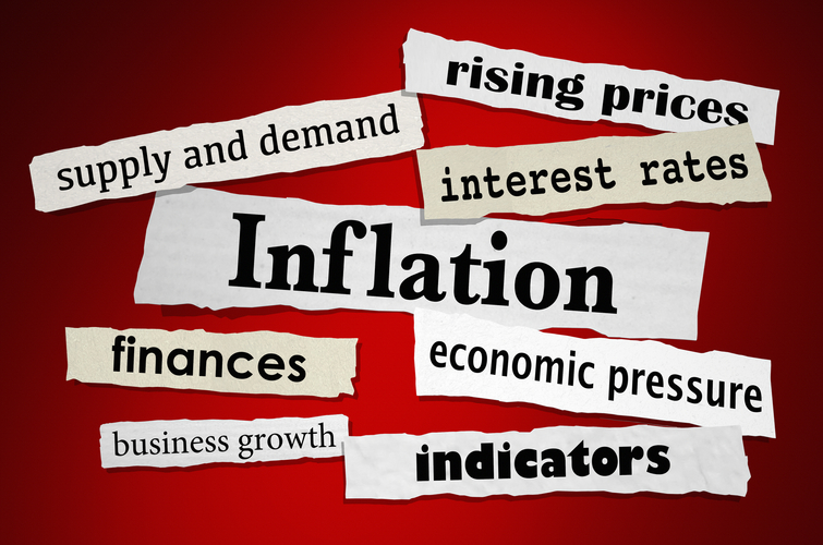 The word inflation is written on a piece of paper on a red background.