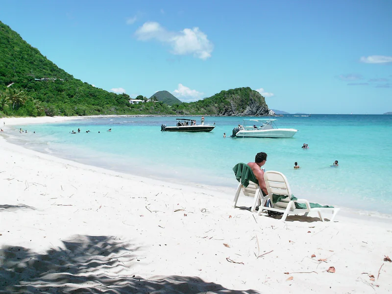 ex-pat relaxing on white sandy beach in British Virgin Islands