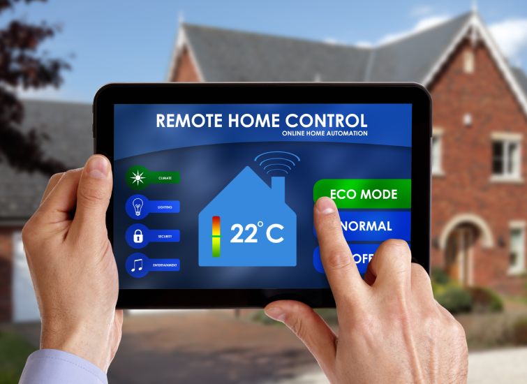 A person holding a tablet with a smart home control on it.