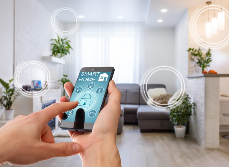 A person enjoying the convenience of a smart home while holding a smart phone in a cozy living room.