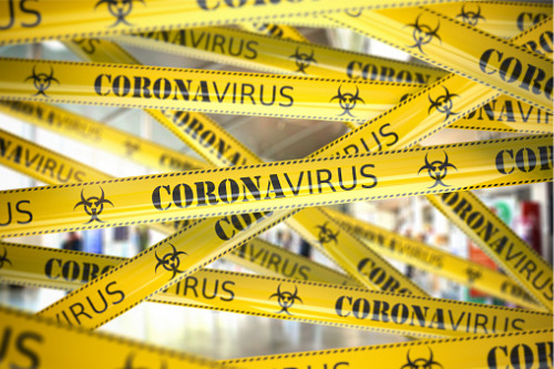 Coronavirus warning tape in a hallway.