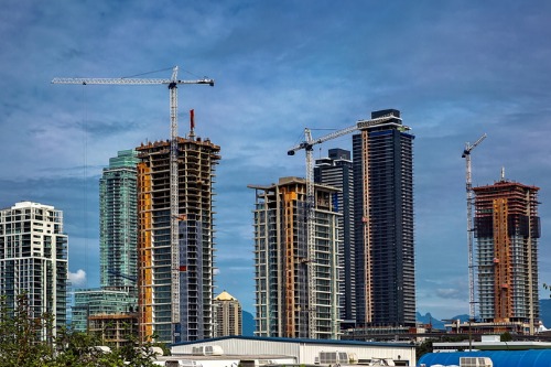 A group of skyscrapers under construction in a city.