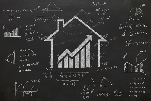 A chalkboard with a house and a graph drawn on it.
