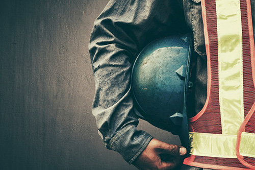 A construction worker wearing a hard hat and safety vest.