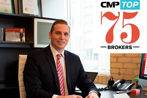 A man in a suit sits at a desk with the cpi top 75 brokers logo.