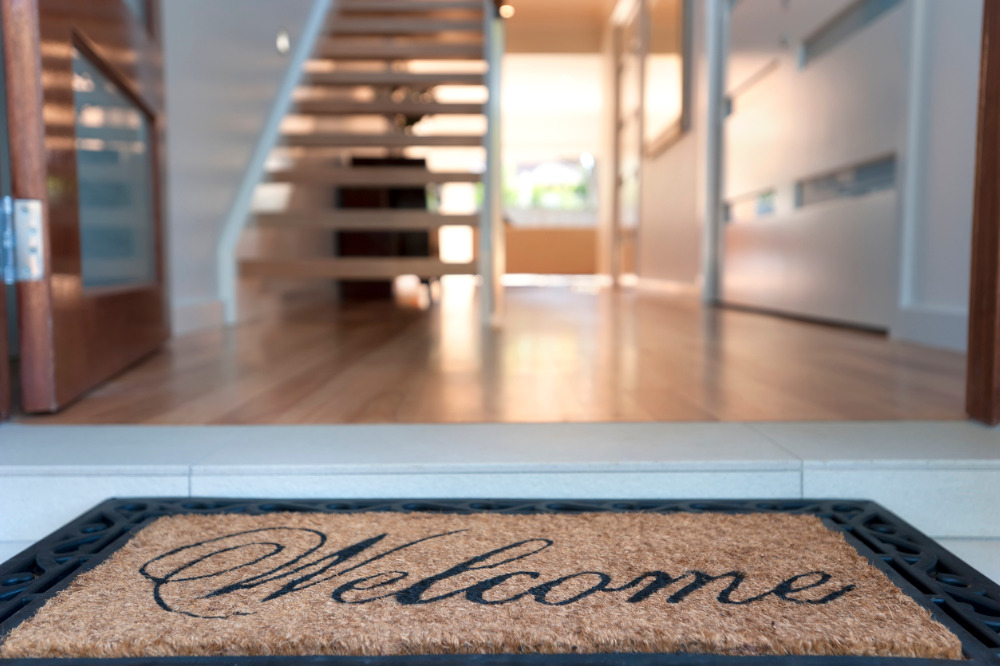 A welcome mat on the floor of a house.