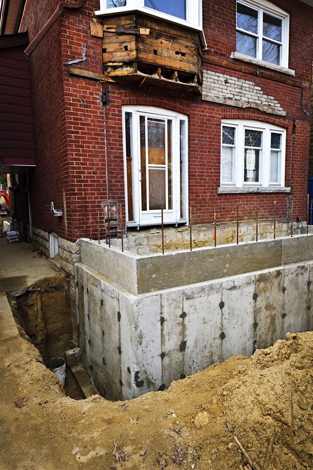 A house with a concrete foundation under construction.