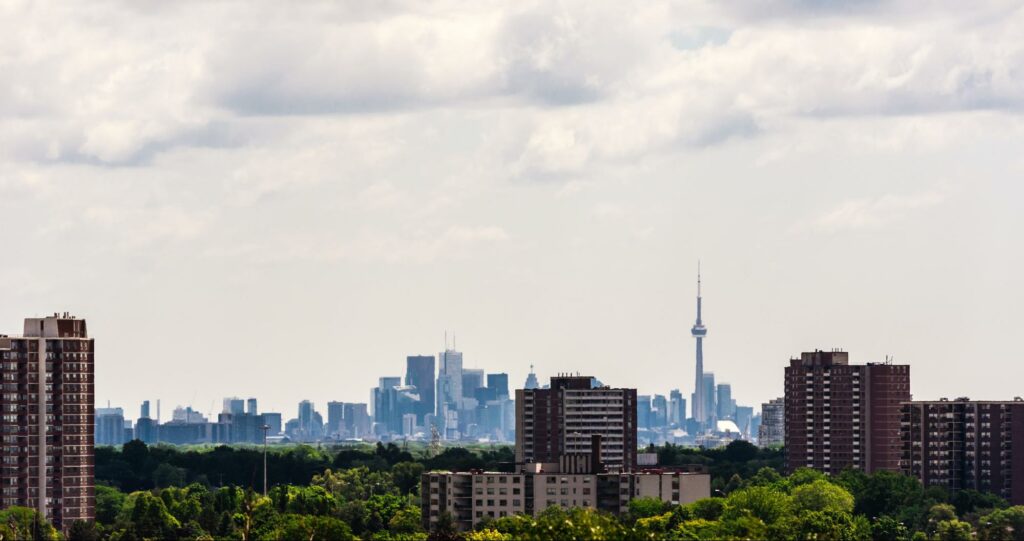 A view of the city of toronto from a park.