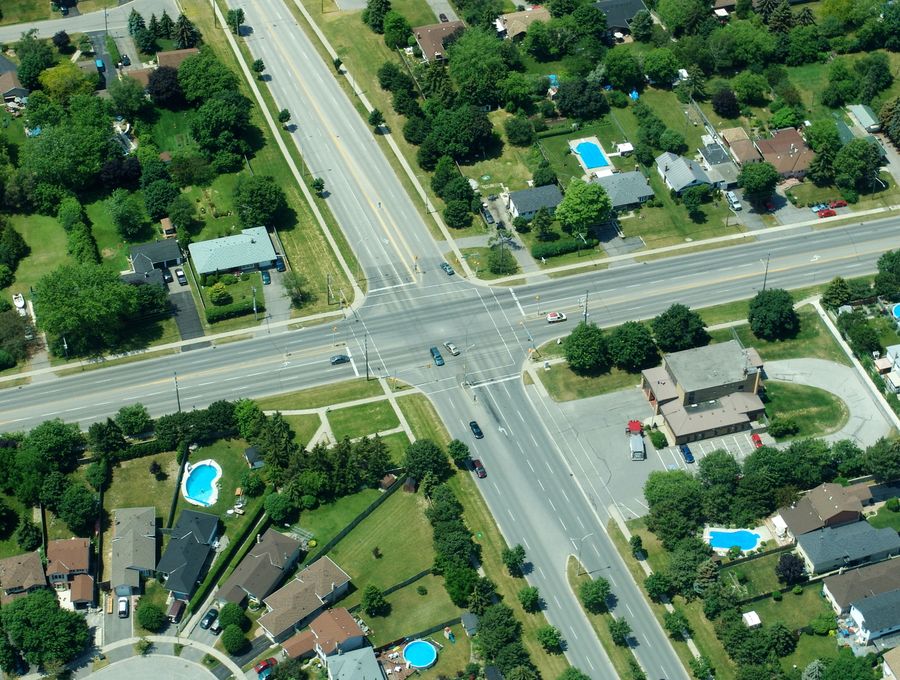 An aerial view of a residential street intersection.