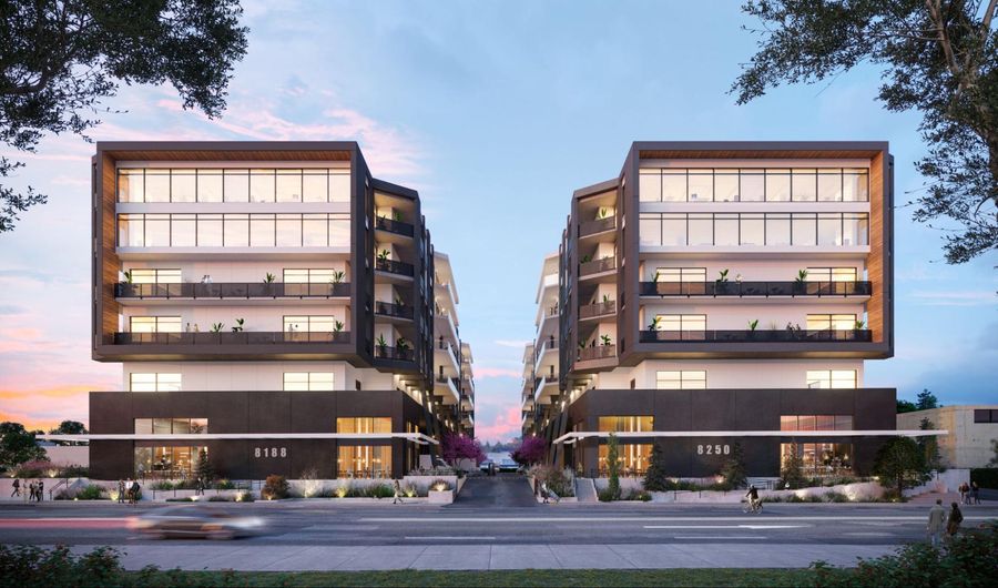 An artist's rendering of an apartment building at dusk.