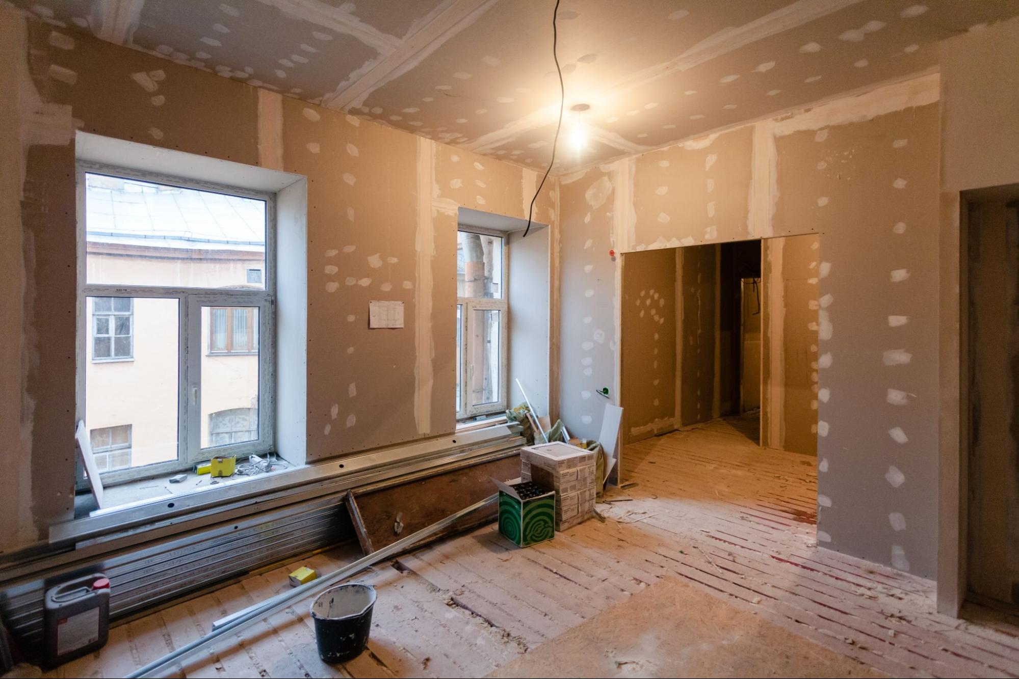 A room is being remodeled with drywall and plaster.