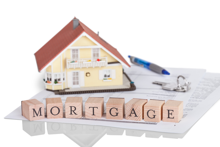A house with the word mortgage on top of a piece of paper.