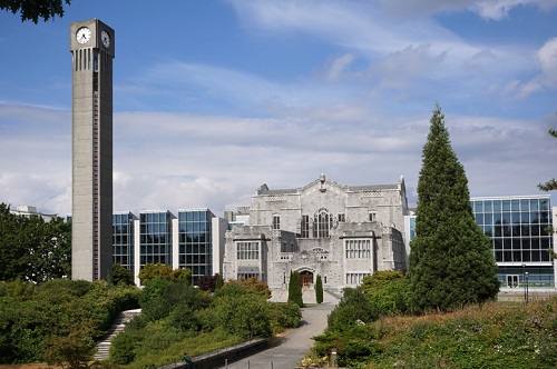 A large building with a clock tower in front of it.