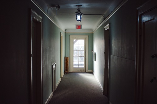 A hallway with a light shining down on it.