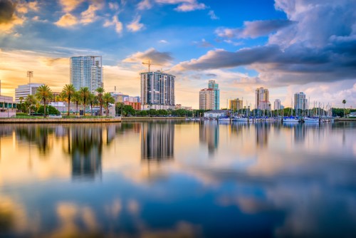 The skyline of tampa, florida is reflected in the water.