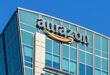 The amazon logo is on top of a building.