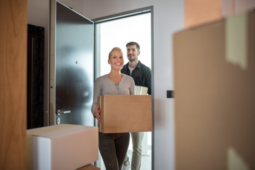 A man and woman are moving into a new home.