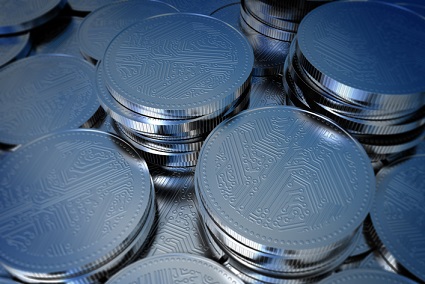 A pile of silver coins on a blue background.