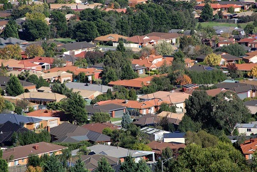 An aerial view of a suburb with many houses and trees.