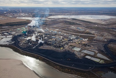 An aerial view of a coal plant near a river.