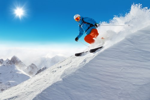 A skier is skiing down a snowy slope.