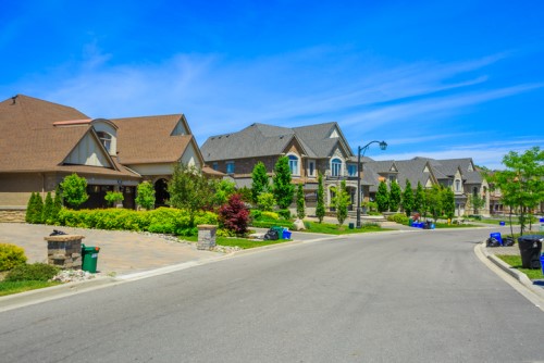 A street full of houses in a suburban neighborhood.