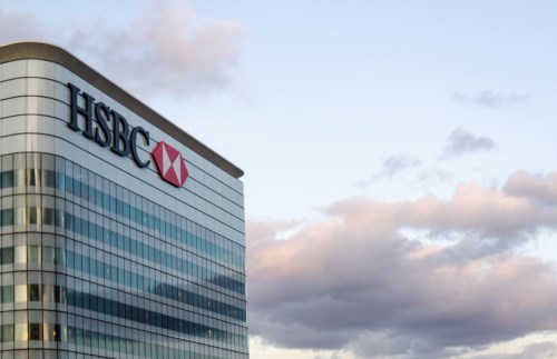 The hsbc building is seen against a cloudy sky.