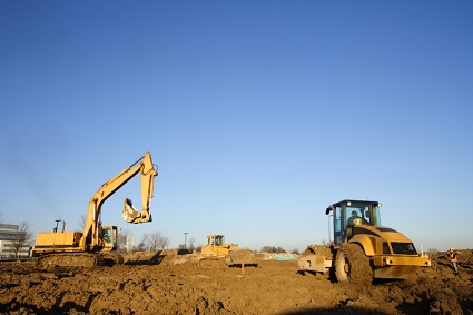 Two bulldozers on a construction site.