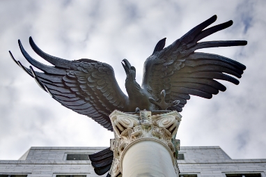 A statue of an eagle on top of a building.