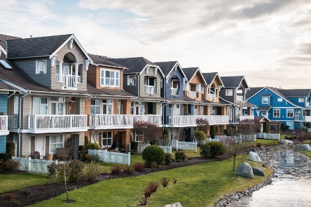 A row of townhouses with a river in the background.