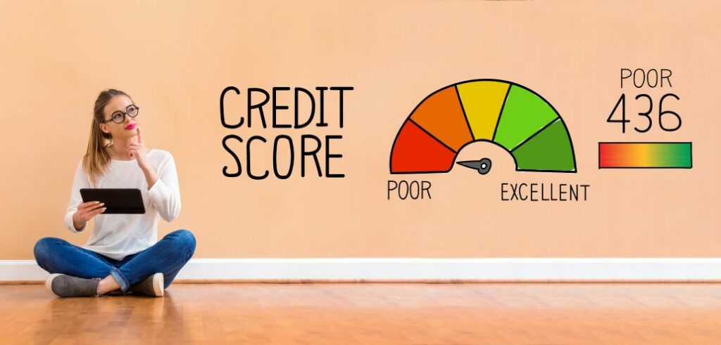 A woman sitting on the floor with a bad credit score displayed on the wall.