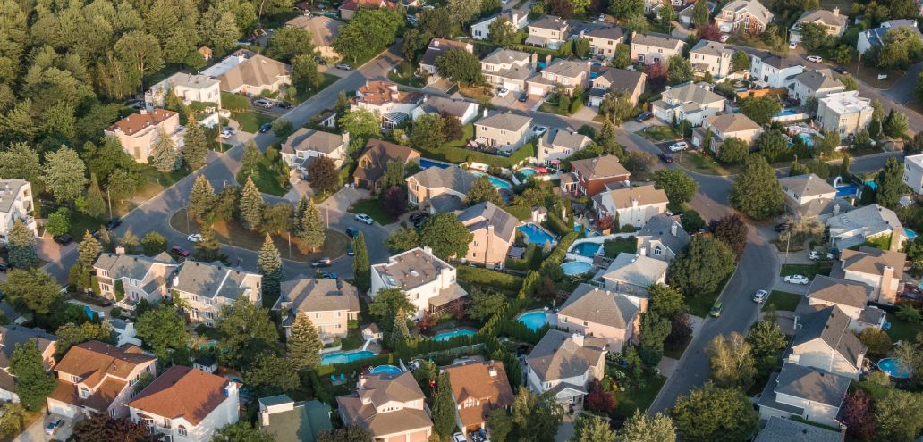 Modified Description: An aerial view of a suburban neighborhood with remote work spaces.