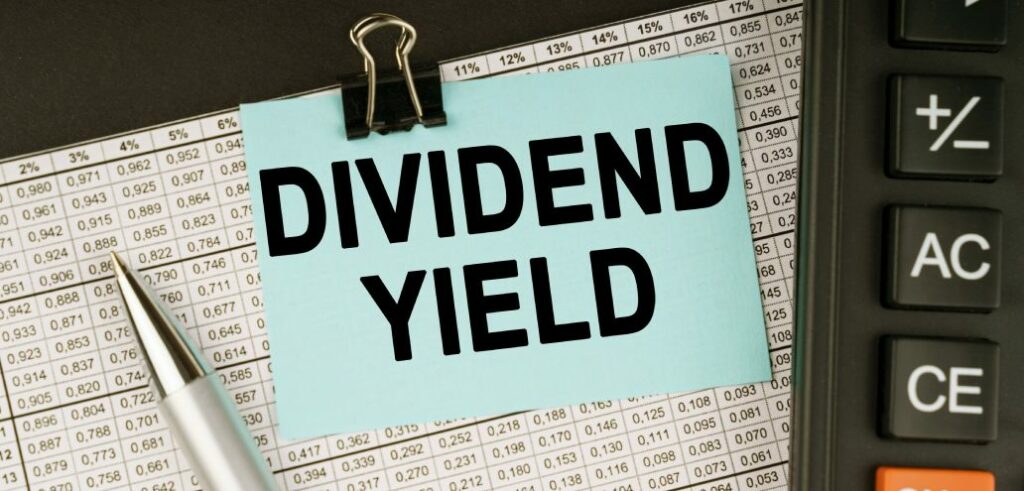 A note with the word dividend yield on it sits on top of a yield calculator.