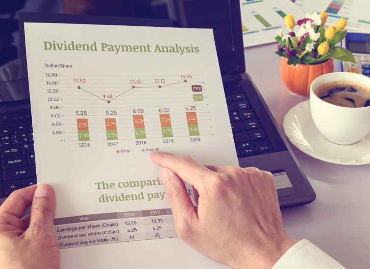 A person holding a paper with the words divided payment analysis and conducting yield calculation.