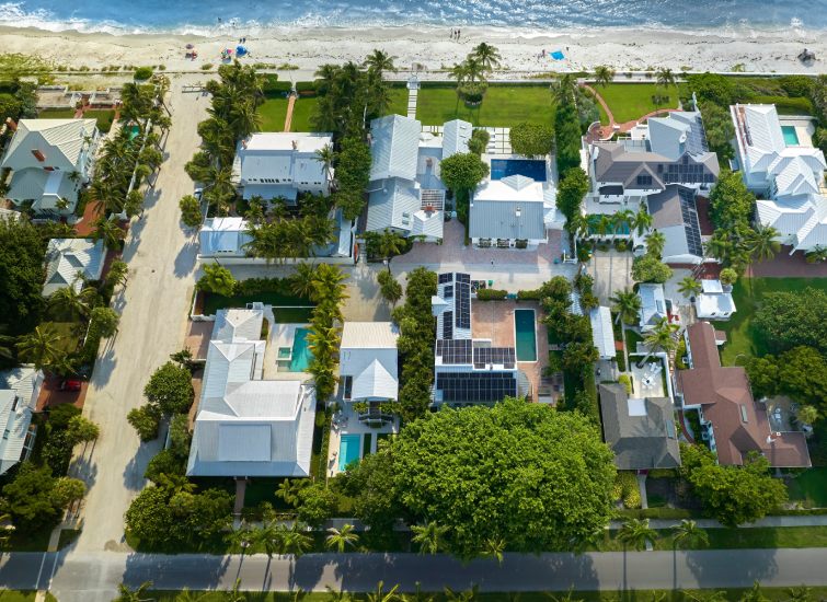 A real estate property with an aerial view, located near the ocean.