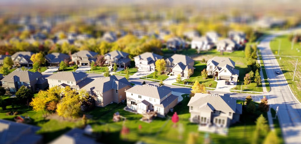 An aerial view of houses in a neighborhood, enticing investors with the potential for growth and profit.