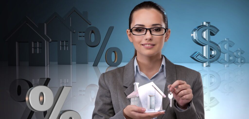 A woman holding up a house model and dollar signs.