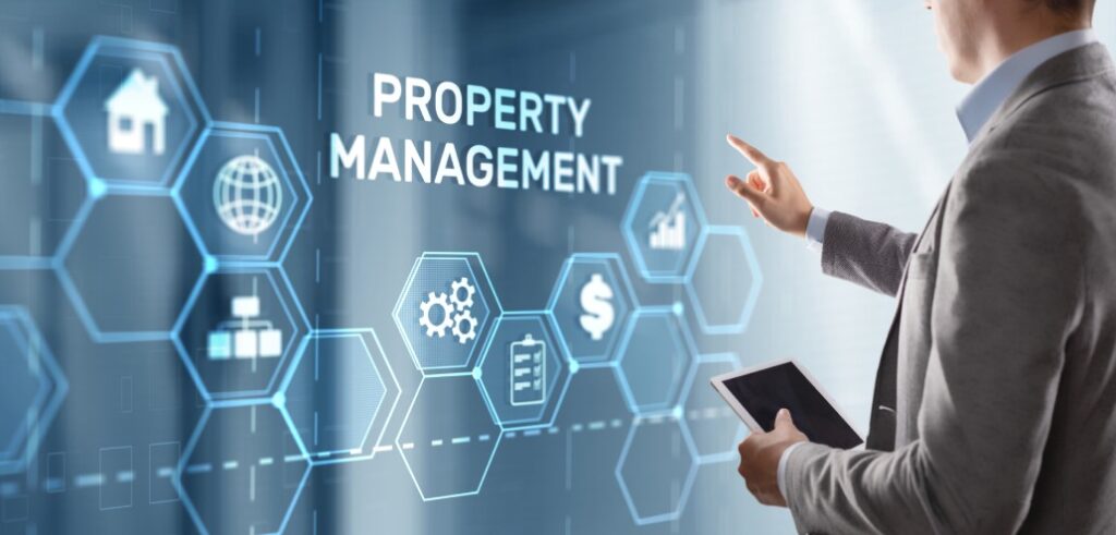 A businessman holding a tablet with property management icons on it.