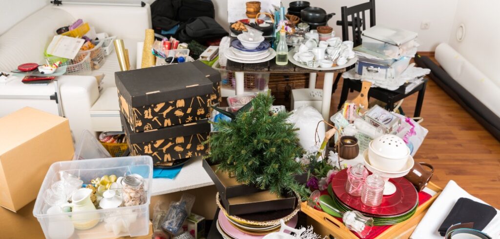 A cluttered room filled with assorted items and boxes indicating disorganization or a pending clean-up.