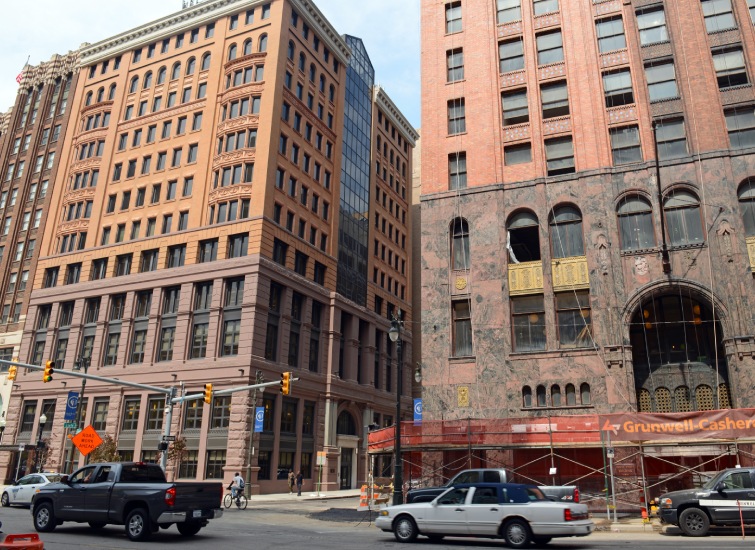 Downtown street view showing a mix of modern and older architectural styles with Metro Detroit Real Estate Investments construction work in progress.